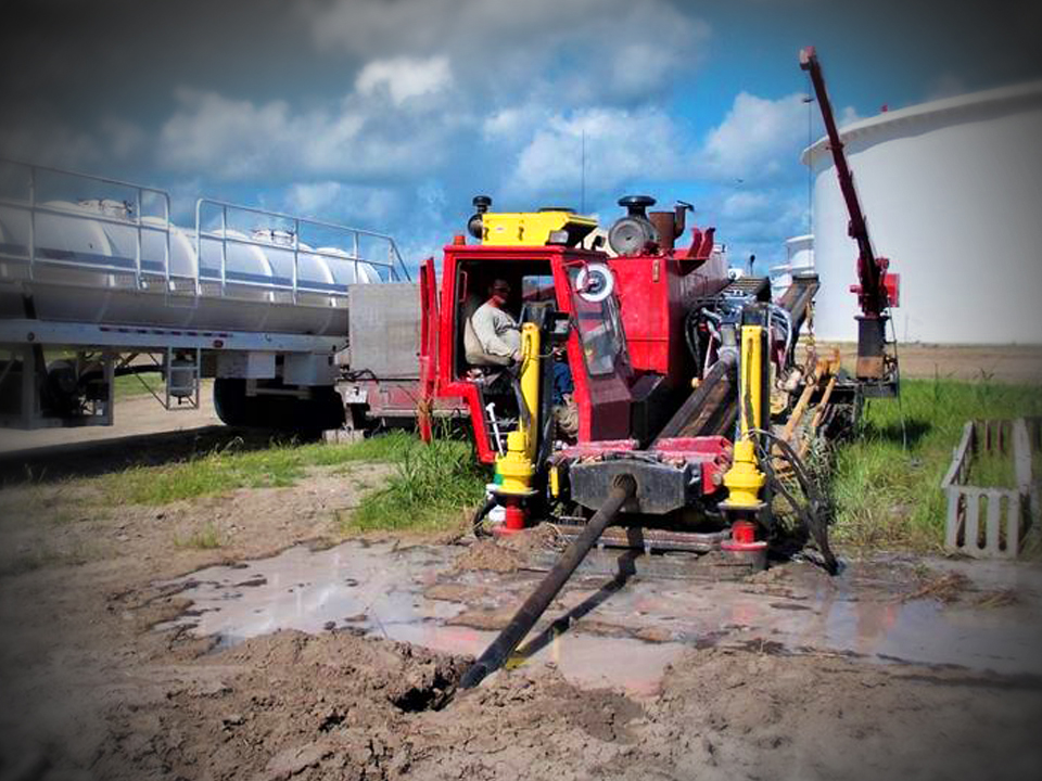 LaGreca worker operating HDD machine with pipe in ground