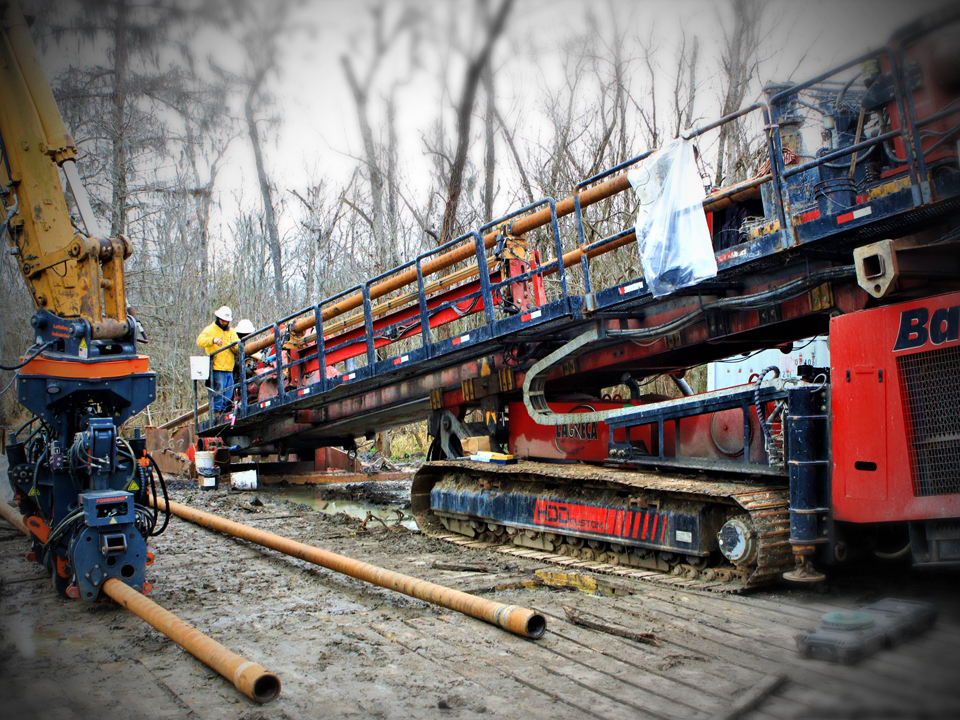 Large HDD machine and pipe in wooded area