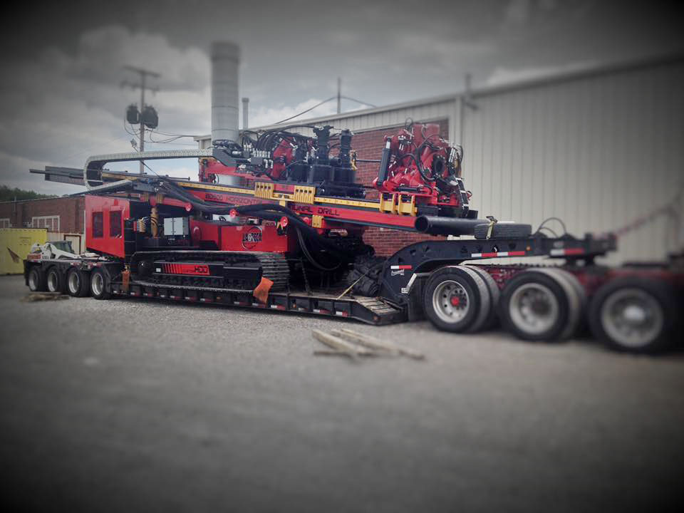 Large red HDD machine on 18 wheeler trailer